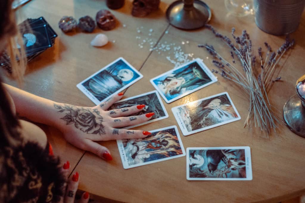 a woman laying out a tarot card spread
