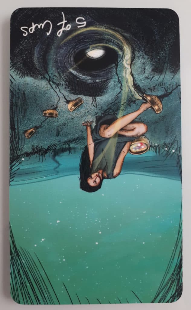 The 5 of Cups tarot card in reversed position from the beautiful The Light Seer’s Tarot Deck